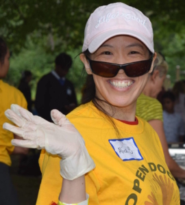 Alice Fong speaker photo waves with a bright smile.